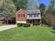 Charming two-story home with a brick facade, attached garage, and a well-manicured front yard at 6645 Austin Creek Dr, Wake Forest, NC 27587