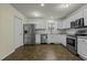 White kitchen with stainless steel appliances and ample counter space at 6645 Austin Creek Dr, Wake Forest, NC 27587