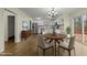 Modern kitchen with white cabinets, stainless steel appliances, and dining area at 6645 Austin Creek Dr, Wake Forest, NC 27587