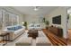 Spacious living room featuring hardwood floors, comfortable seating, and large windows at 6645 Austin Creek Dr, Wake Forest, NC 27587