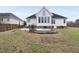 Back of home with a large yard featuring a patio, fire pit, and privacy fence at 701 Occoneechee Dr, Fuquay Varina, NC 27526