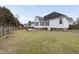 View of backyard with a patio, fire pit, and privacy fence, perfect for outdoor enjoyment at 701 Occoneechee Dr, Fuquay Varina, NC 27526