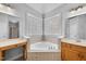 Bathroom with a corner bathtub and a bright vanity at 701 Occoneechee Dr, Fuquay Varina, NC 27526