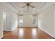 Bright bedroom with hardwood floors, ceiling fan, and two windows at 701 Occoneechee Dr, Fuquay Varina, NC 27526