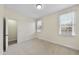 Clean bedroom with neutral walls, carpet flooring, and windows providing natural light at 701 Occoneechee Dr, Fuquay Varina, NC 27526