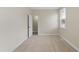 Well-lit bedroom featuring neutral walls, carpet flooring, and a door to a closet at 701 Occoneechee Dr, Fuquay Varina, NC 27526