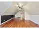 A spacious bedroom featuring hardwood floors and unique architectural details and a ceiling fan at 701 Occoneechee Dr, Fuquay Varina, NC 27526