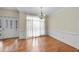 Dining room with hardwood flooring, chair railing, and a door to the outside at 701 Occoneechee Dr, Fuquay Varina, NC 27526
