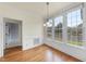 Bright dining room with hardwood floors, and natural light from the large windows at 701 Occoneechee Dr, Fuquay Varina, NC 27526