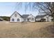 Charming exterior of a light colored two-story home with a manicured lawn at 701 Occoneechee Dr, Fuquay Varina, NC 27526