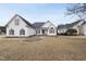 Charming exterior of a light colored two-story home and well manicured lawn at 701 Occoneechee Dr, Fuquay Varina, NC 27526