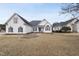 White two-story house with a gray roof and a landscaped yard at 701 Occoneechee Dr, Fuquay Varina, NC 27526