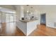 Bright kitchen with white cabinets, stainless appliances, and open to the dining room at 701 Occoneechee Dr, Fuquay Varina, NC 27526