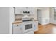 Kitchen features a white stove, microwave, and plenty of cabinet space at 701 Occoneechee Dr, Fuquay Varina, NC 27526