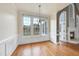 Dining room with large windows, chandelier, and hardwood floors opening up to a living room at 701 Occoneechee Dr, Fuquay Varina, NC 27526