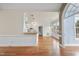 Open-concept living space with hardwood floors, kitchen, and large windows providing natural light at 701 Occoneechee Dr, Fuquay Varina, NC 27526