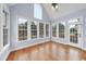 Sun room filled with natural light from large windows, vaulted ceiling, and hardwood floors at 701 Occoneechee Dr, Fuquay Varina, NC 27526