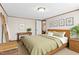 Relaxing main bedroom showcasing a wood bed, natural light, and a minimalist design at 7945 Nc 42, Holly Springs, NC 27540