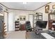 This is an interior view of the home office, featuring a traditional desk, black office chair, and multiple shelves at 7945 Nc 42, Holly Springs, NC 27540