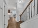 Clean hallway with hardwood floors and a staircase to the upper level at 7949 Parker Mill Trl, Fuquay Varina, NC 27526