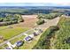 Aerial view showcases homes surrounded by nature, featuring lush green forests and open fields at 798 Christian Light Rd, Fuquay Varina, NC 27526