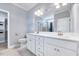 Bright bathroom featuring double sink vanity, walk-in shower, linen closet and modern fixtures at 798 Christian Light Rd, Fuquay Varina, NC 27526