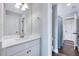 Bright bathroom features a vanity with white cabinets and a shower at 798 Christian Light Rd, Fuquay Varina, NC 27526