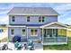 Back of the house features a patio and a screened-in porch, ideal for outdoor enjoyment and relaxation at 798 Christian Light Rd, Fuquay Varina, NC 27526