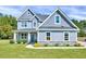Charming two-story home with gray siding, shingle accents, landscaped yard, and covered front porch at 798 Christian Light Rd, Fuquay Varina, NC 27526