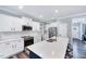 Modern kitchen, white cabinets, quartz countertops, and island at 798 Christian Light Rd, Fuquay Varina, NC 27526