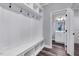Bright mudroom featuring white storage cabinets, coat hooks and access to the downstairs bathroom at 798 Christian Light Rd, Fuquay Varina, NC 27526