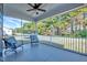 Relaxing screened porch with ceiling fan and comfortable seating overlooking the green, fenced backyard at 798 Christian Light Rd, Fuquay Varina, NC 27526