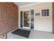 Brick building entrance with glass door, keypad, and unit number signage at 800 Moratuck Dr # 308, Raleigh, NC 27604