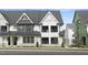 Two-story townhome with modern farmhouse style, gray accents, and metal roof at 917 Myers Point Dr # 21, Morrisville, NC 27560