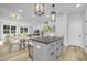 Open concept kitchen with gray island and white cabinets at 917 Myers Point Dr # 21, Morrisville, NC 27560