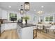 Open concept kitchen with gray island and white cabinets at 917 Myers Point Dr # 21, Morrisville, NC 27560