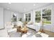 Bright living room features a plush white sofa and large windows at 917 Myers Point Dr # 21, Morrisville, NC 27560