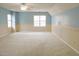 Large main bedroom with light blue and beige walls and a ceiling fan at 1 Danforth Pl, Durham, NC 27712