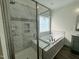 An elegant bathroom features a separate shower, soaker tub, and attractive marble design at 100 Preacher Ln, Angier, NC 27501