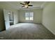 A bright bedroom with a ceiling fan, carpet, a large window and white trim at 100 Preacher Ln, Angier, NC 27501