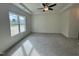 A bright bedroom offers a large window, neutral carpet and a ceiling fan at 100 Preacher Ln, Angier, NC 27501