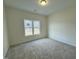 Neutral bedroom features carpeted floor and a window overlooking the outdoors, creating a calming space at 100 Preacher Ln, Angier, NC 27501