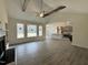 Bright living room featuring a fireplace, vaulted ceiling with beams, wood flooring and large windows at 100 Preacher Ln, Angier, NC 27501