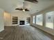 Spacious living room with a fireplace, built-in shelves, and large windows for natural light at 100 Preacher Ln, Angier, NC 27501