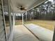 Covered patio with a ceiling fan looks out onto a level backyard with mature trees at 100 Preacher Ln, Angier, NC 27501