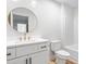 Modern bathroom featuring a round mirror, gold fixtures, and white vanity, toilet, and shower at 1040 Southern High School Rd, Burlington, NC 27215