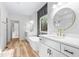 Bright bathroom featuring double vanity, a soaking tub, updated fixtures, and wood-look tile floors at 1040 Southern High School Rd, Burlington, NC 27215
