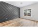 Stylish bedroom boasts a modern accent wall, sleek flooring, and a bright window at 1040 Southern High School Rd, Burlington, NC 27215