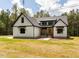 Beautiful two-story home with white siding, black accents, and well-manicured lawn at 1040 Southern High School Rd, Burlington, NC 27215