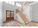 Inviting foyer with wood staircase and stylish wood and glass front door at 1040 Southern High School Rd, Burlington, NC 27215
